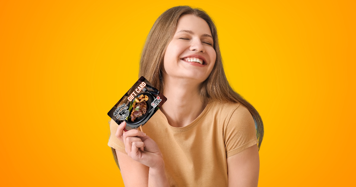 Image of a woman holding a restaurant gift card looking very happy with the words Multi-channel Gift Cards and the Dine Local logo