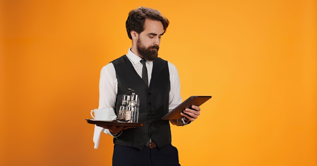 A person holds a smartphone with the Dine Local restaurant ordering screen in front of them with the words "How Online Ordering Boosts Restaurant Efficiency" overlayed