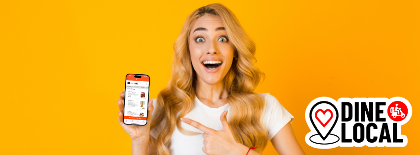 Picture of a woman holding a phone with the Dine Local App pointing at the phone with the look of surprise and delight indicating her pleasure with the delivery discount she is receiving.