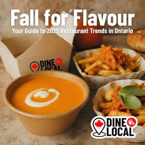 A warm, top-down view of a steaming bowl of pumpkin soup, Korean BBQ poutine, and a pulled jackfruit sandwich on a fall table that has been delivered by Dine Local as a takeout order.